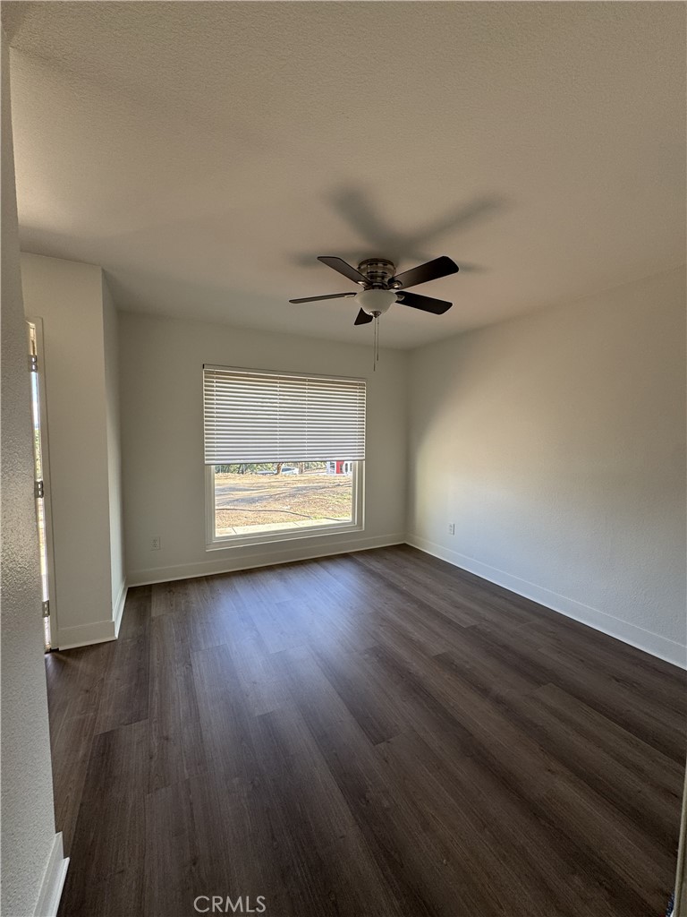 15521 Saddleback Road Woodcrest, CA 92506 - Photo 16 of 24 an empty room with wooden floor and windows