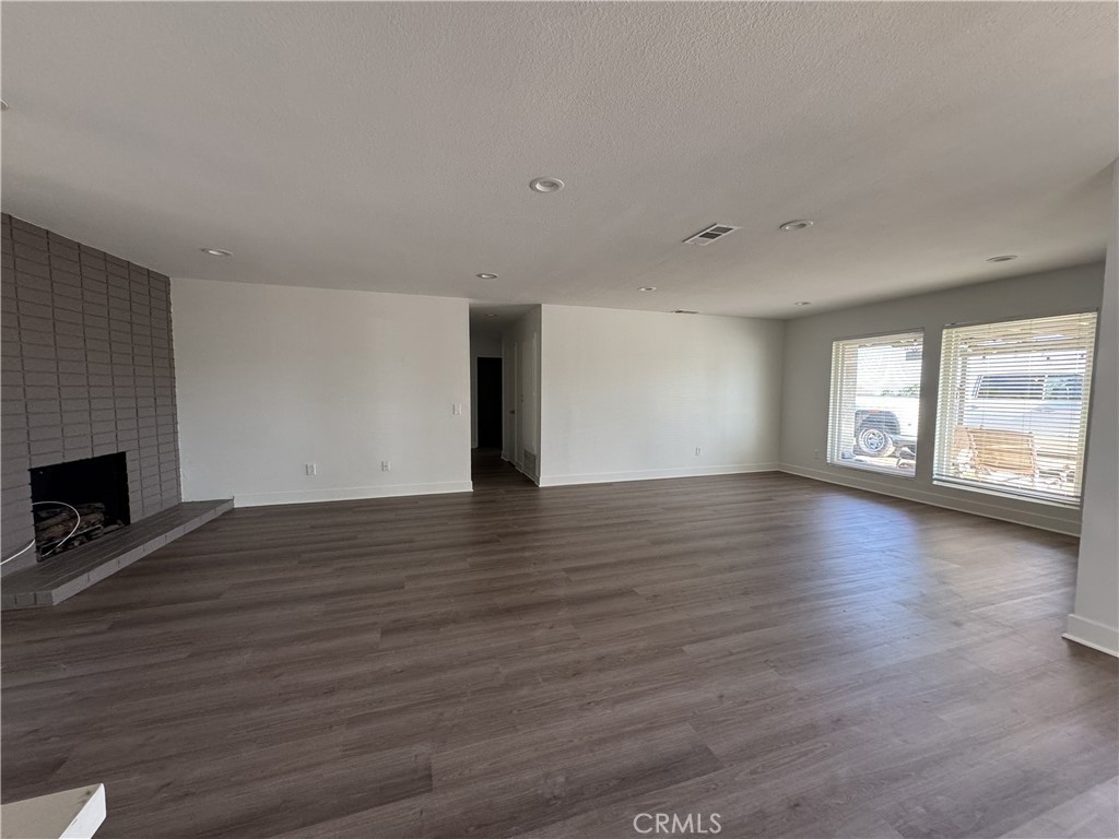 15521 Saddleback Road Woodcrest, CA 92506 - Photo 17 of 24 a view of an empty room with wooden floor and a window