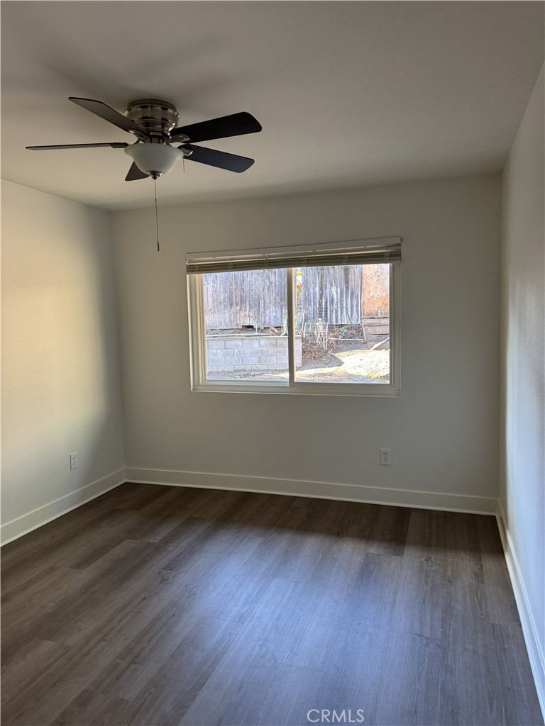 15521 Saddleback Road Woodcrest, CA 92506 - Photo 19 of 24 an empty room with wooden floor and windows