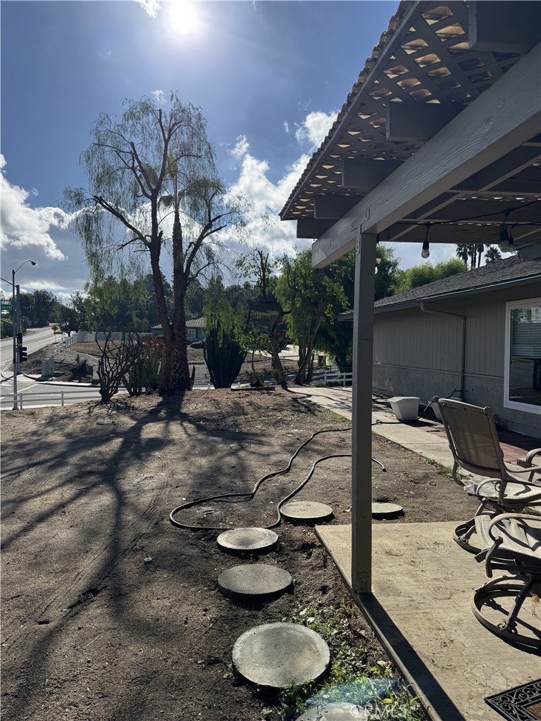 15521 Saddleback Road Woodcrest, CA 92506 - Photo 6 of 24 a backyard of a house with dining table and chairs