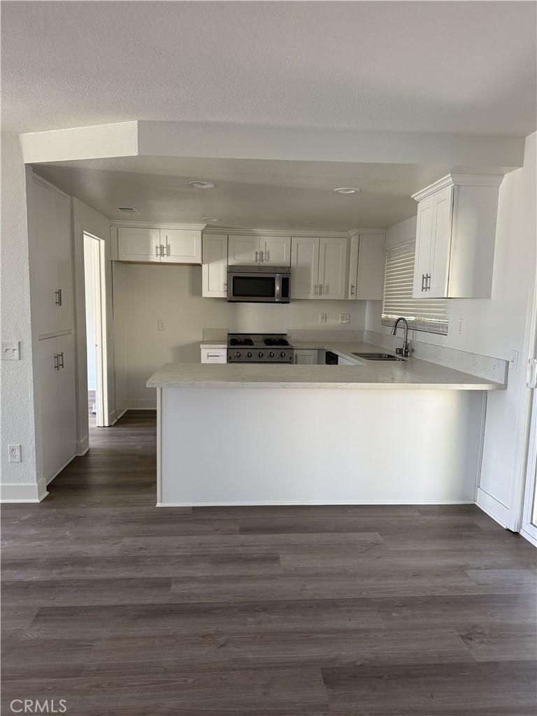 15521 Saddleback Road Woodcrest, CA 92506 - Photo 8 of 24 a view of kitchen with stainless steel appliances granite countertop a stove a sink and a refrigerator
