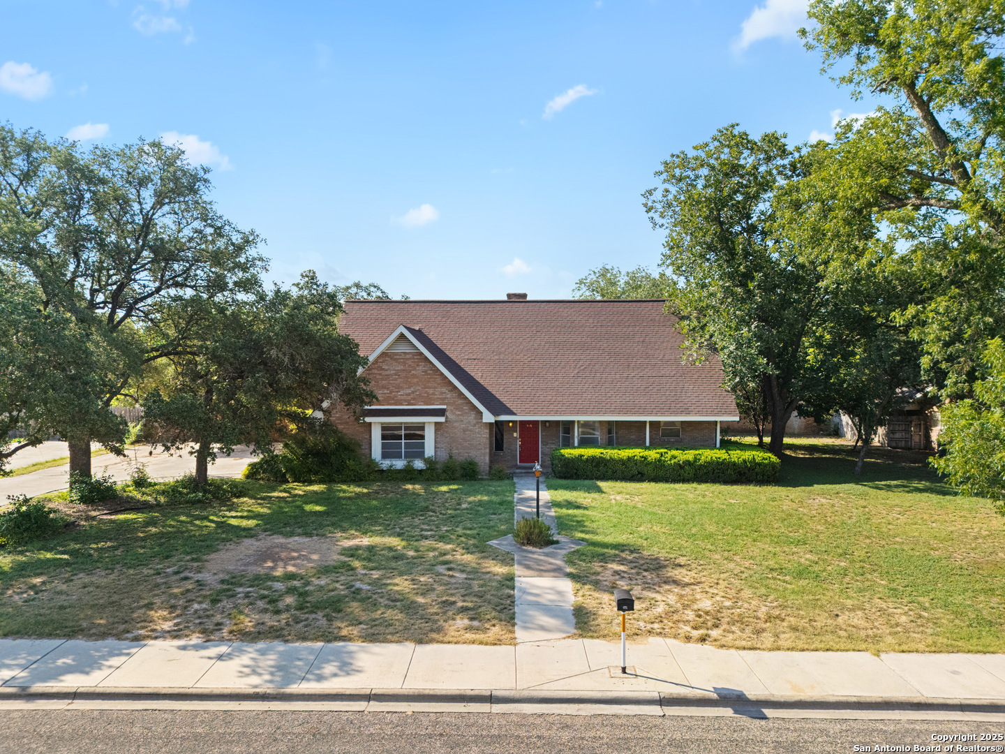 a front view of house with yard and green space