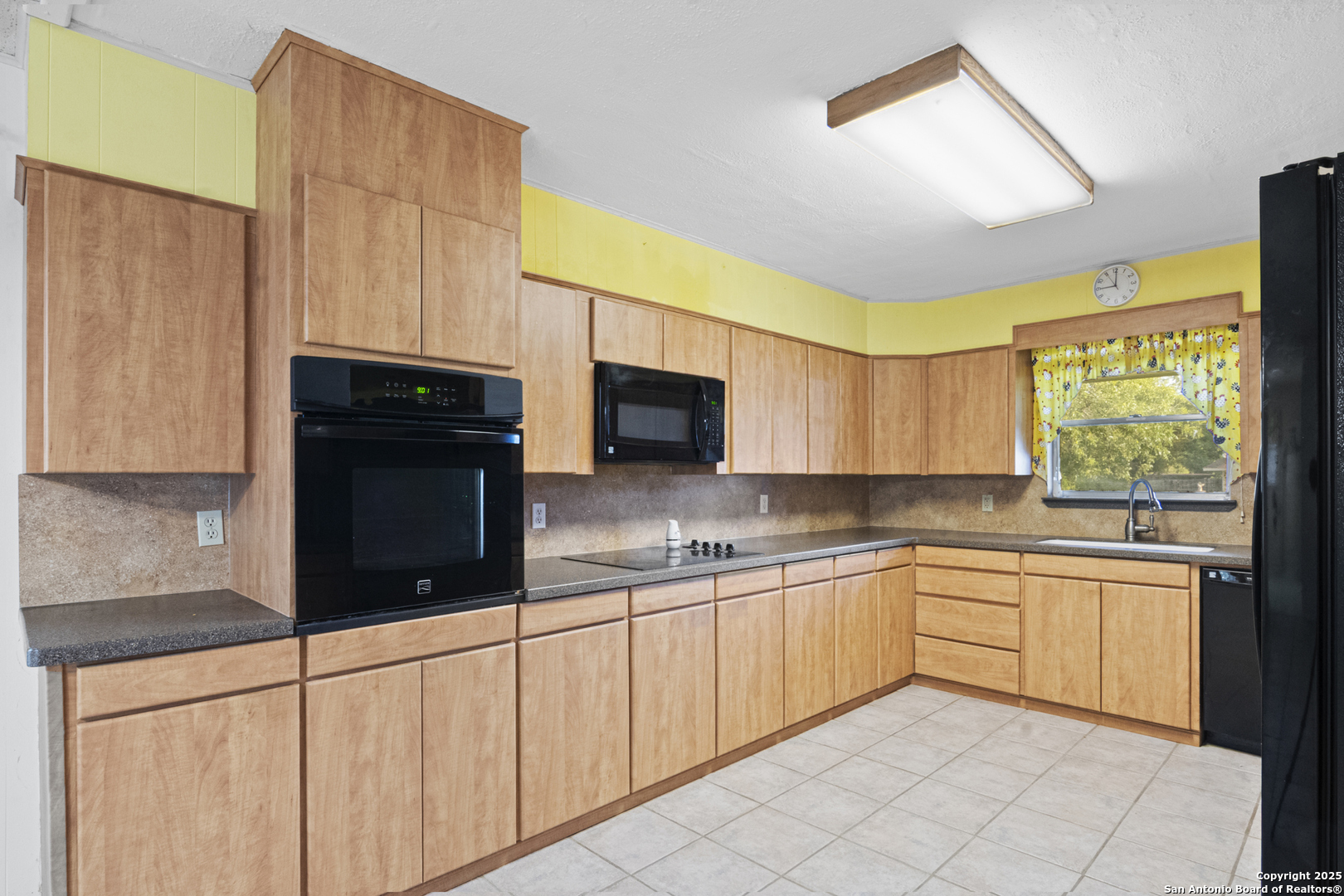 715 Studer Street Uvalde, TX 78801 - Photo 11 of 44 a kitchen with stainless steel appliances a stove a sink and a microwave