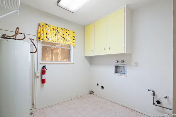 a view of an empty room with cabinet