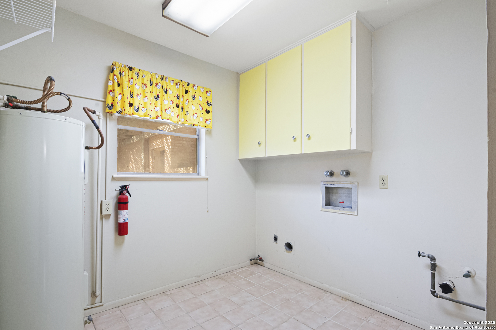 715 Studer Street Uvalde, TX 78801 - Photo 15 of 44 a view of storage and utility room with a window
