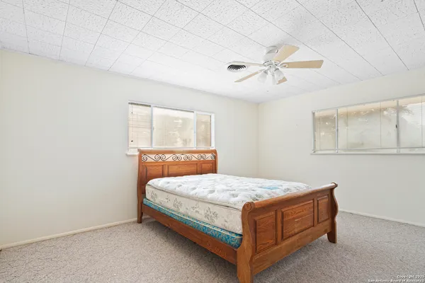 a bathroom with a sink a window and a shower