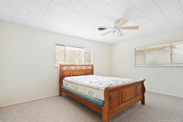 a bathroom with a sink a window and a shower