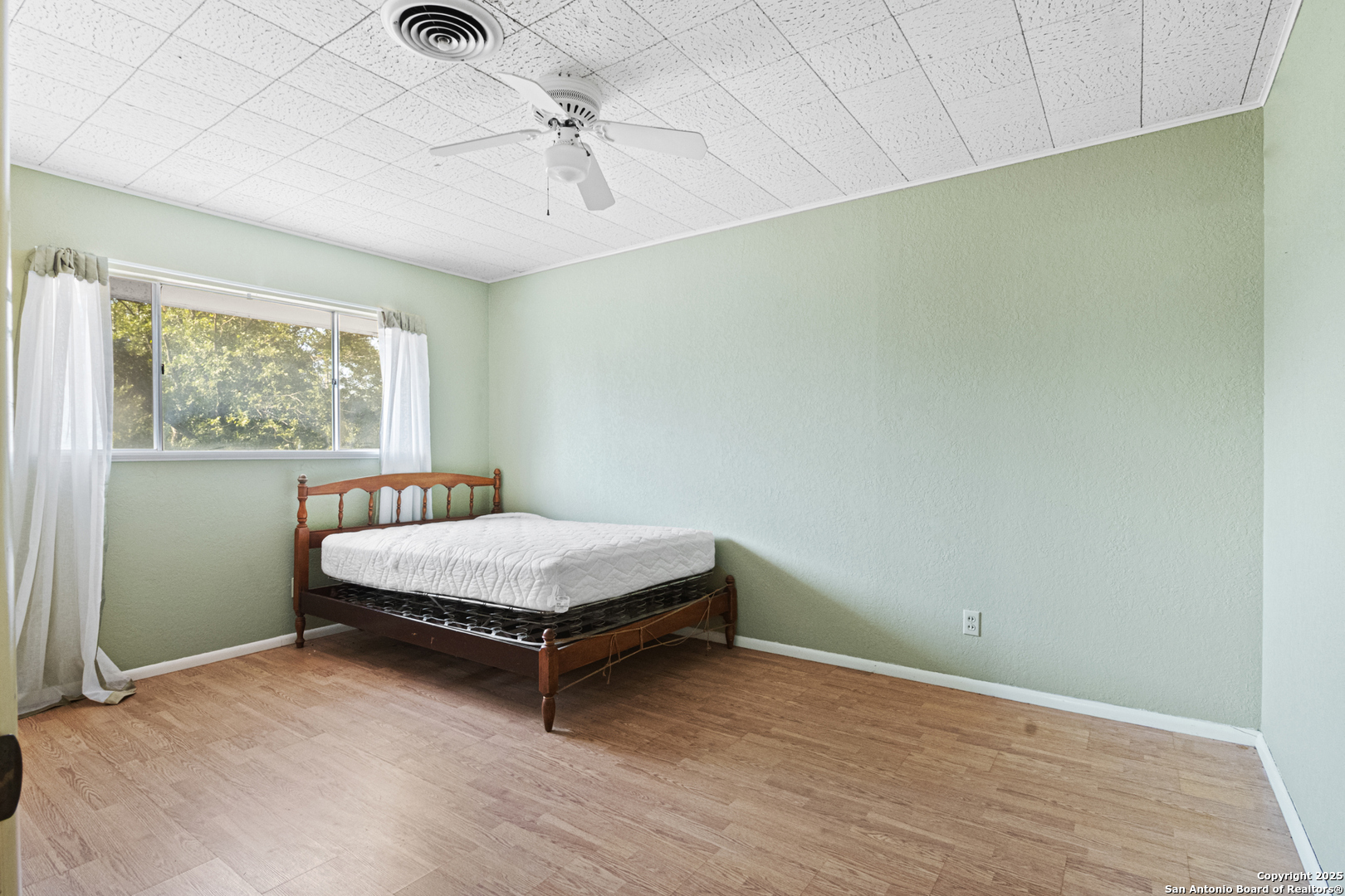715 Studer Street Uvalde, TX 78801 - Photo 29 of 44 a room with a bed and a window