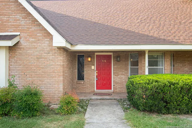 a front view of brick house with potted plants
