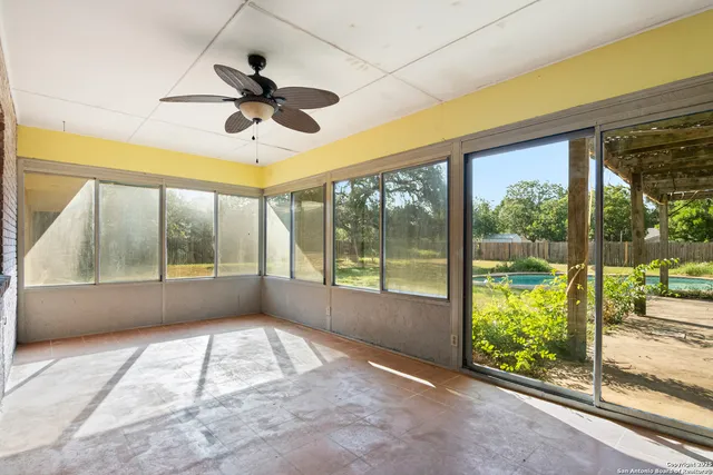 a view of an empty room with wooden fence