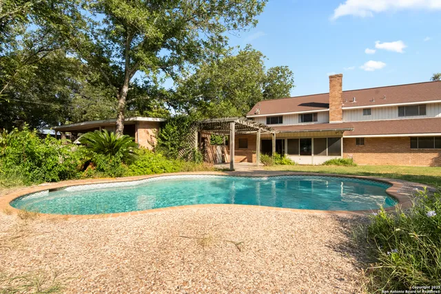 a view of a backyard with a tree