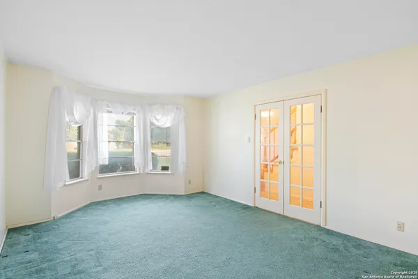 a view of empty room with window and fireplace