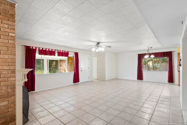 a view of a livingroom with an empty space and a fireplace