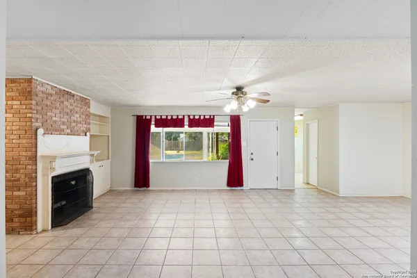 a large white kitchen with a large window