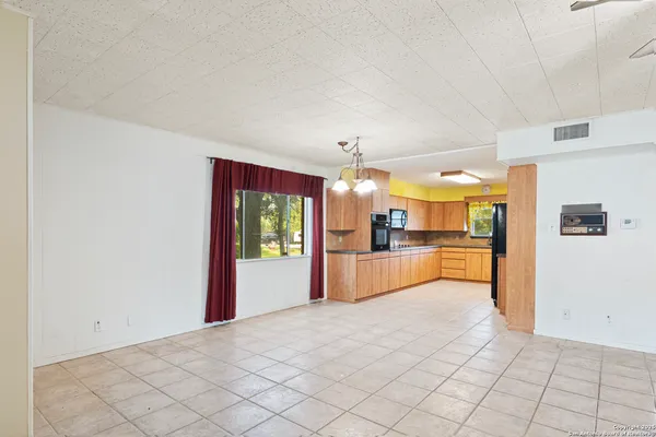 a kitchen with stainless steel appliances granite countertop a refrigerator a oven and a sink