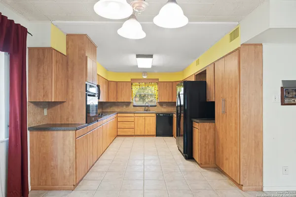 a kitchen with stainless steel appliances a stove a sink and a microwave