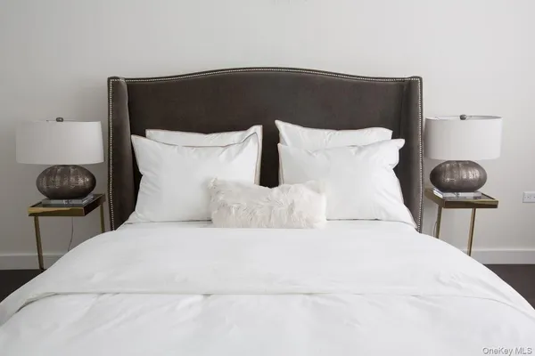 a bedroom with a bed and a chair