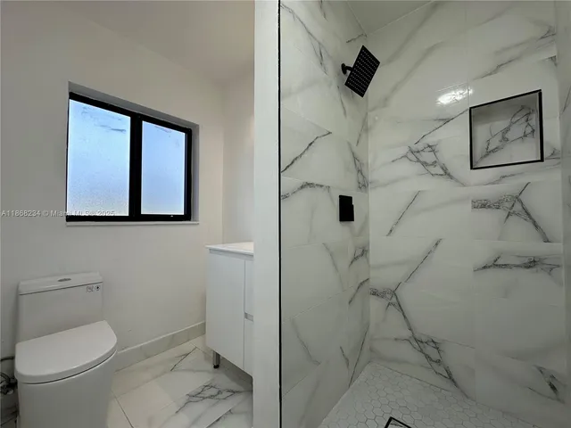 a bathroom with a toilet sink and shower