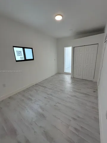 a backyard of a house with a yard and trampoline