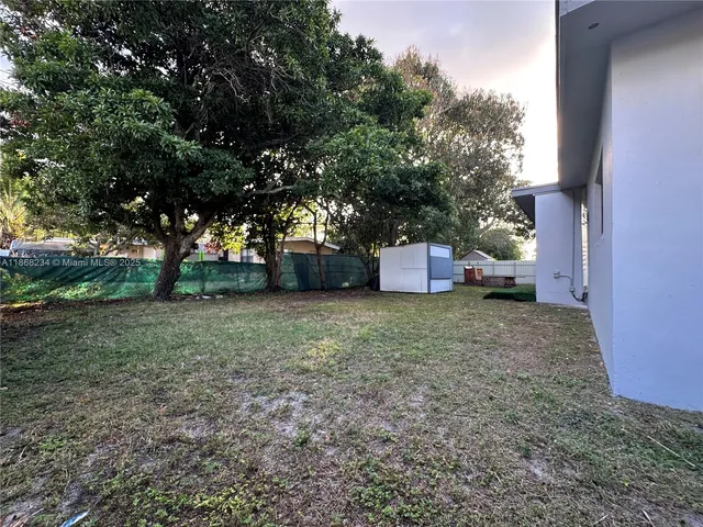 a yellow house with trees in front of it