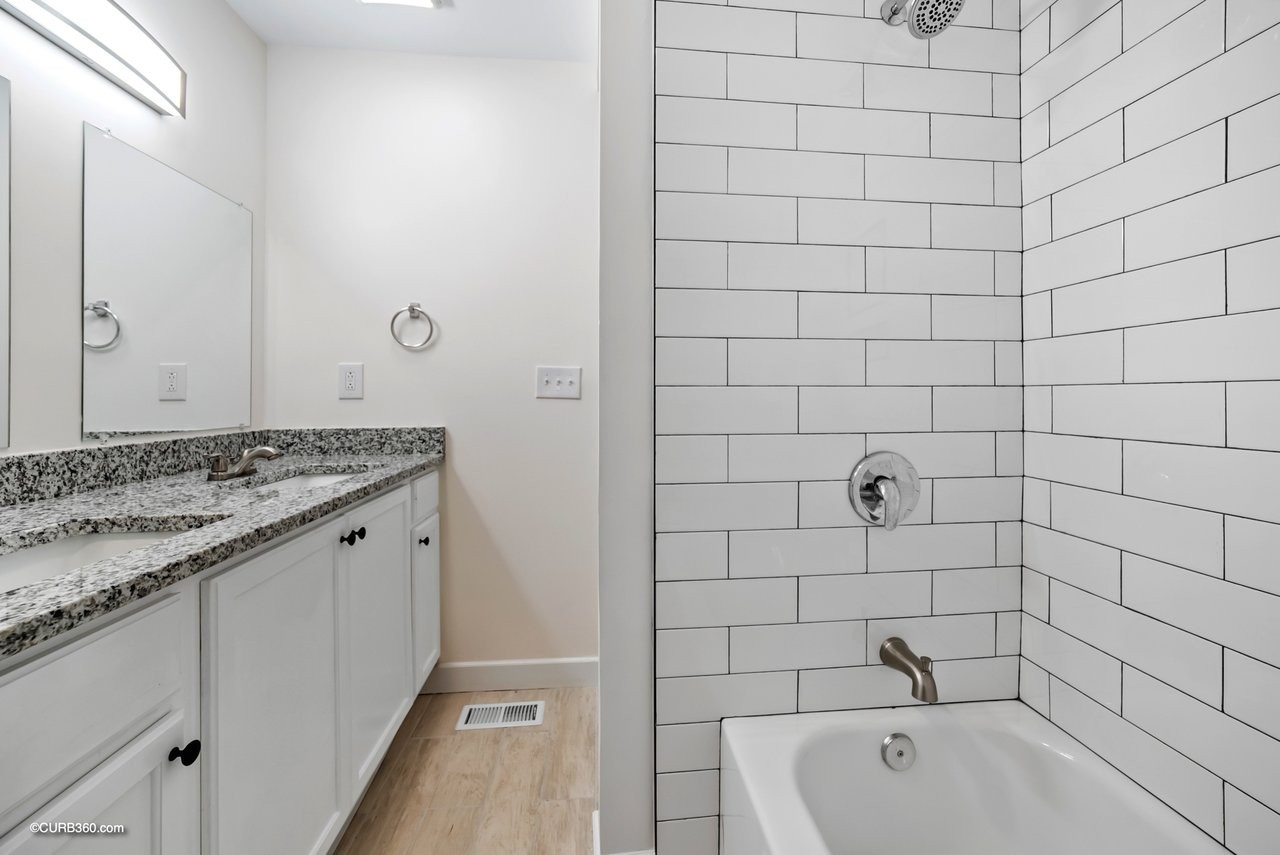 491 Rural Hill Road Nashville, TN 37217 - Photo 24 of 32 a bathroom with a granite countertop sink and bathtub
