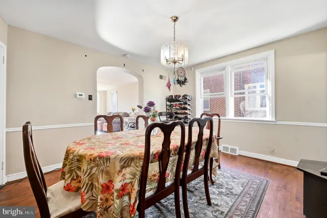 a view of a dining room with furniture and a chandelier