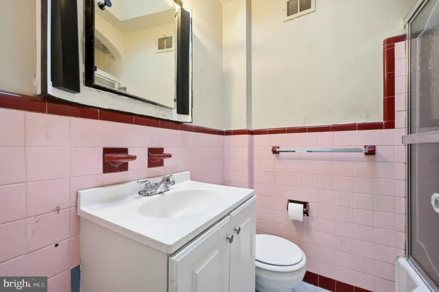 a bathroom with a sink vanity and a toilet