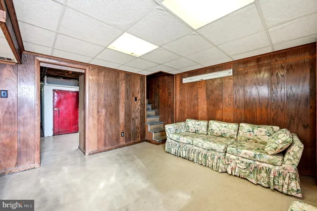 a bed sitting in a spacious bedroom next to a window