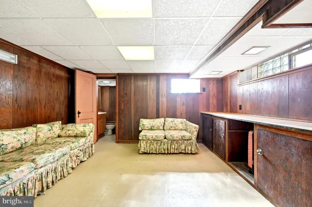 a spacious bedroom with a bed and a dresser