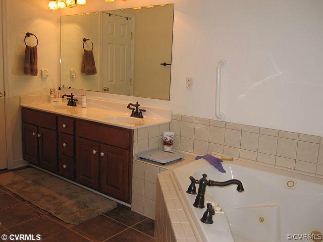 535 Levi Road Green Bay, VA 23942 - Photo 11 of 19 a bathroom with a double vanity sink a mirror and a shower