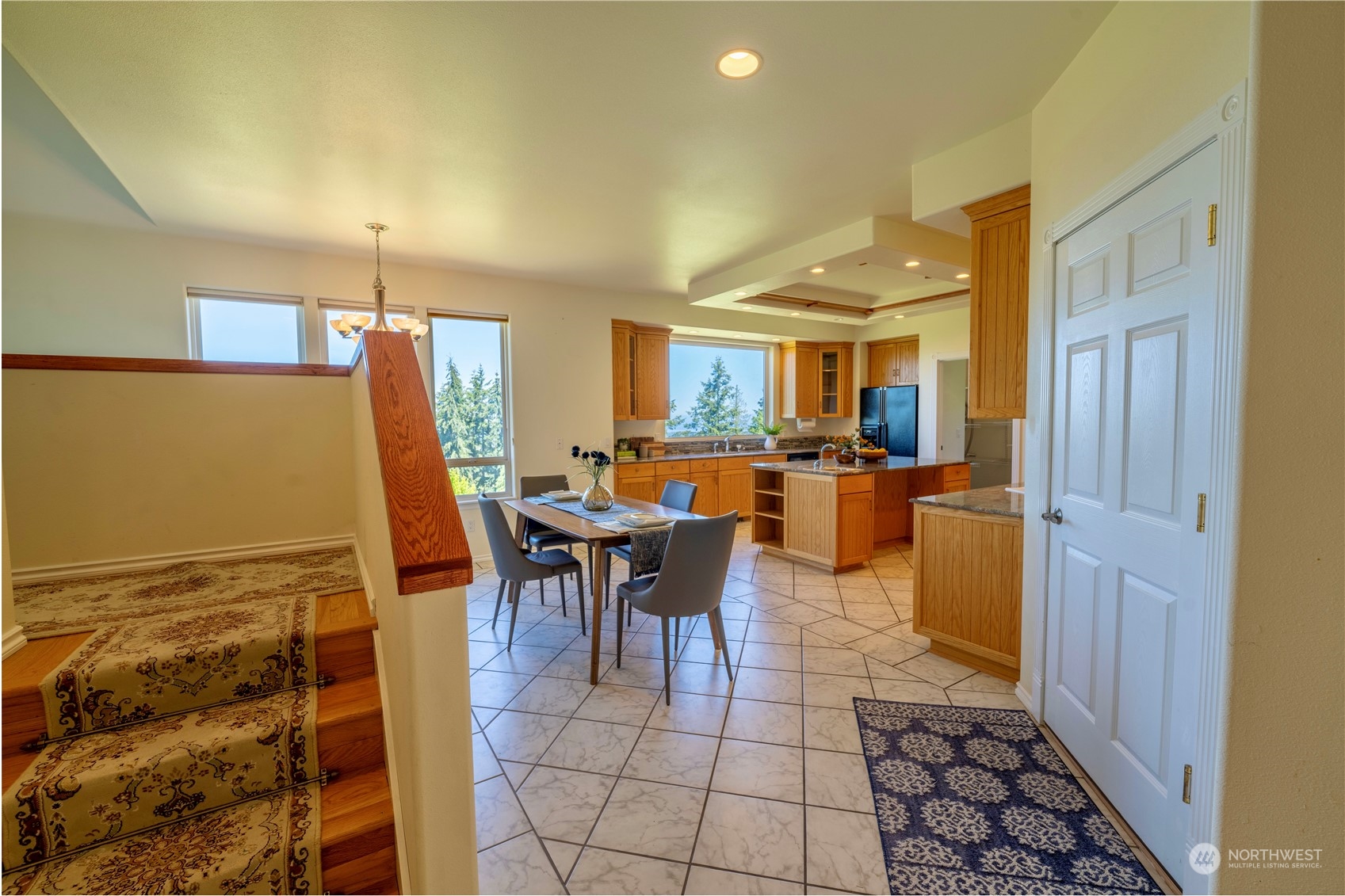 272 Ravens Ridge Road Sequim, WA 98382 - Photo 12 of 40 a dining hall with stainless steel appliances a dining table and chairs