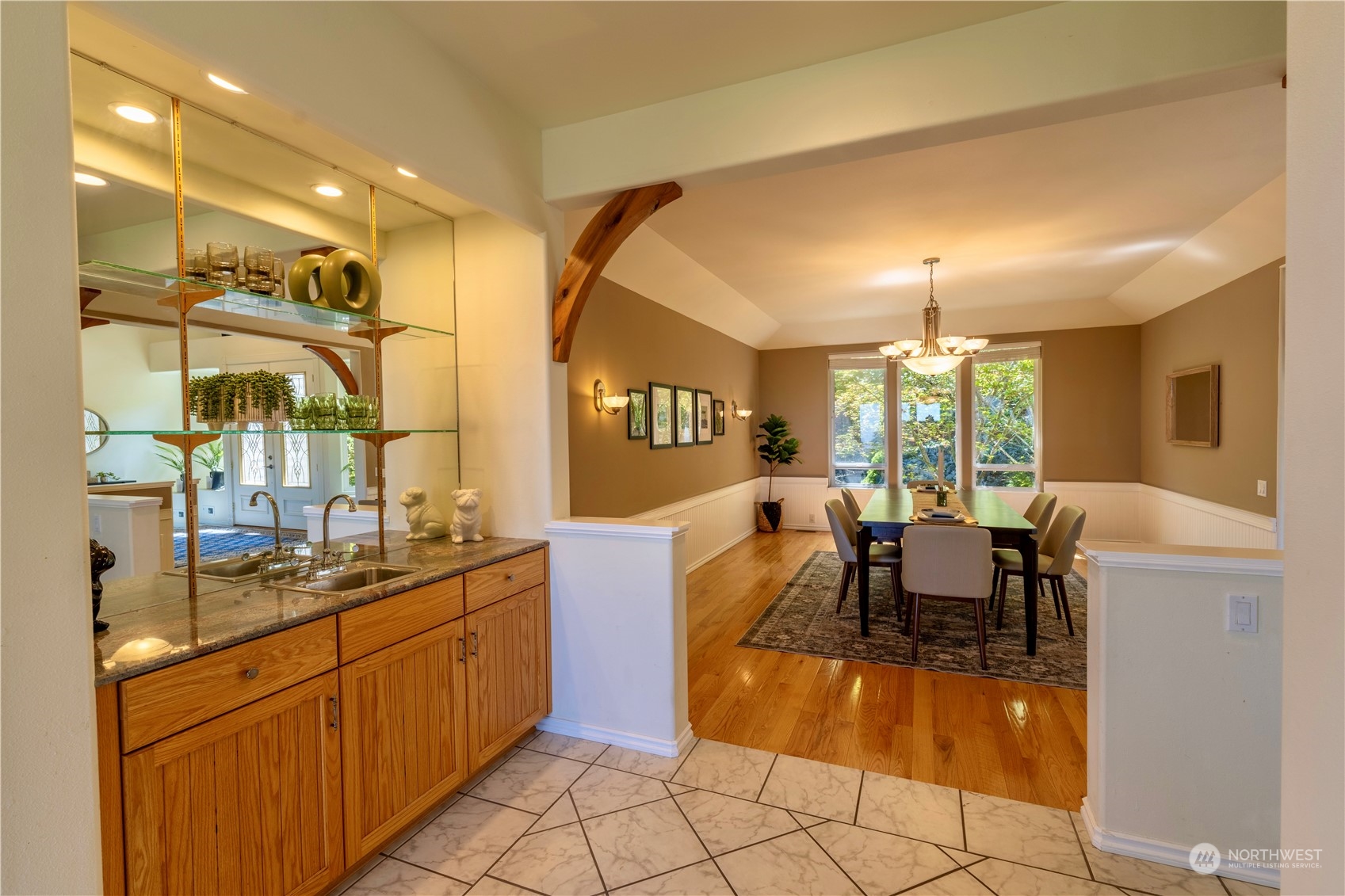 272 Ravens Ridge Road Sequim, WA 98382 - Photo 14 of 40 a dining hall with stainless steel appliances kitchen island granite countertop a sink and cabinets
