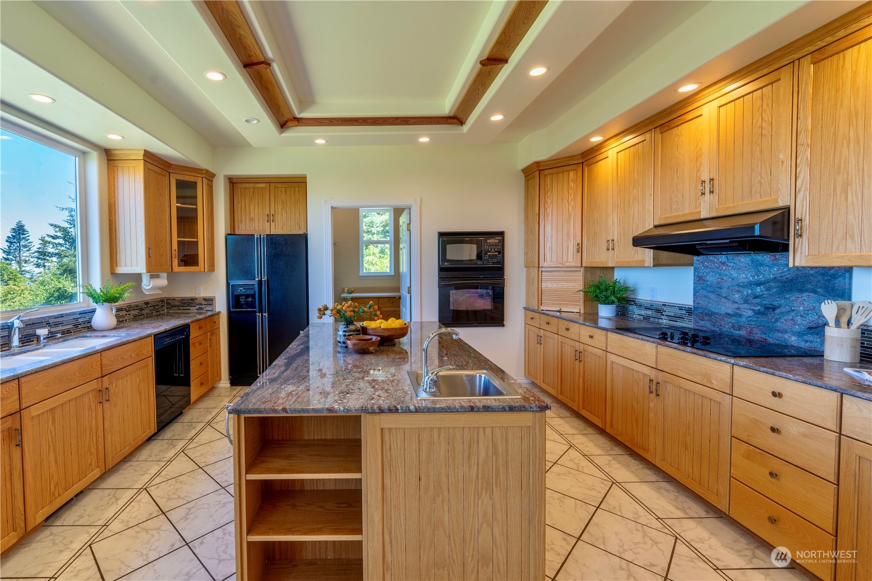 272 Ravens Ridge Road Sequim, WA 98382 - Photo 17 of 40 a kitchen with stainless steel appliances kitchen island granite countertop a sink and cabinets