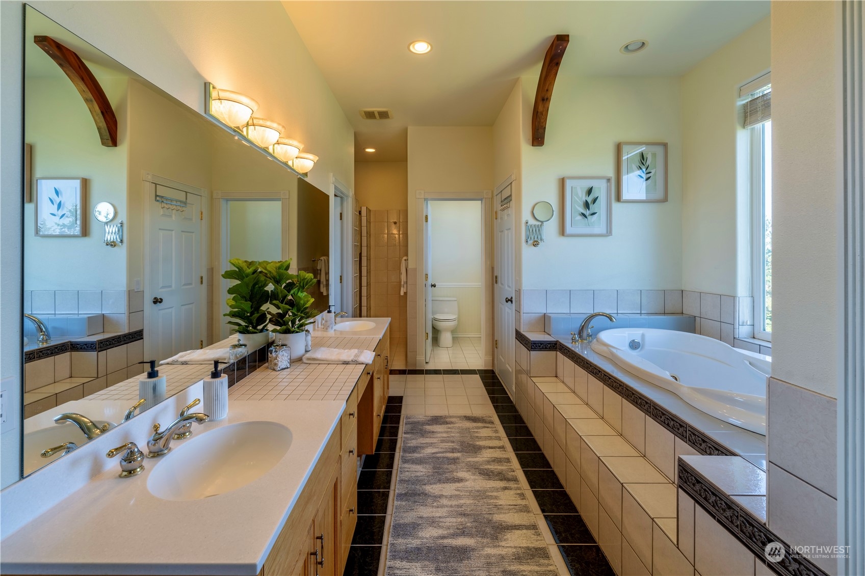 272 Ravens Ridge Road Sequim, WA 98382 - Photo 28 of 40 a bathroom with a granite countertop double vanity sink a mirror and a bathtub