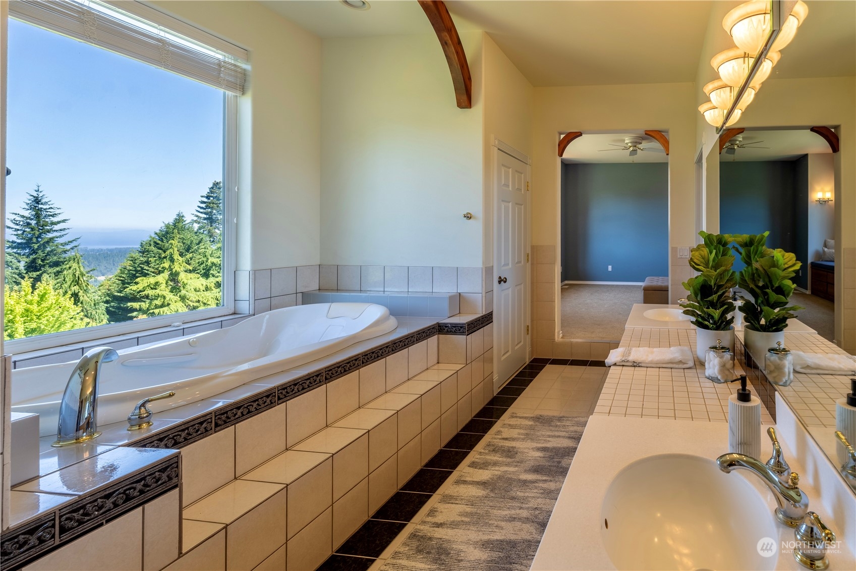 272 Ravens Ridge Road Sequim, WA 98382 - Photo 29 of 40 a bathroom with a tub and a large mirror