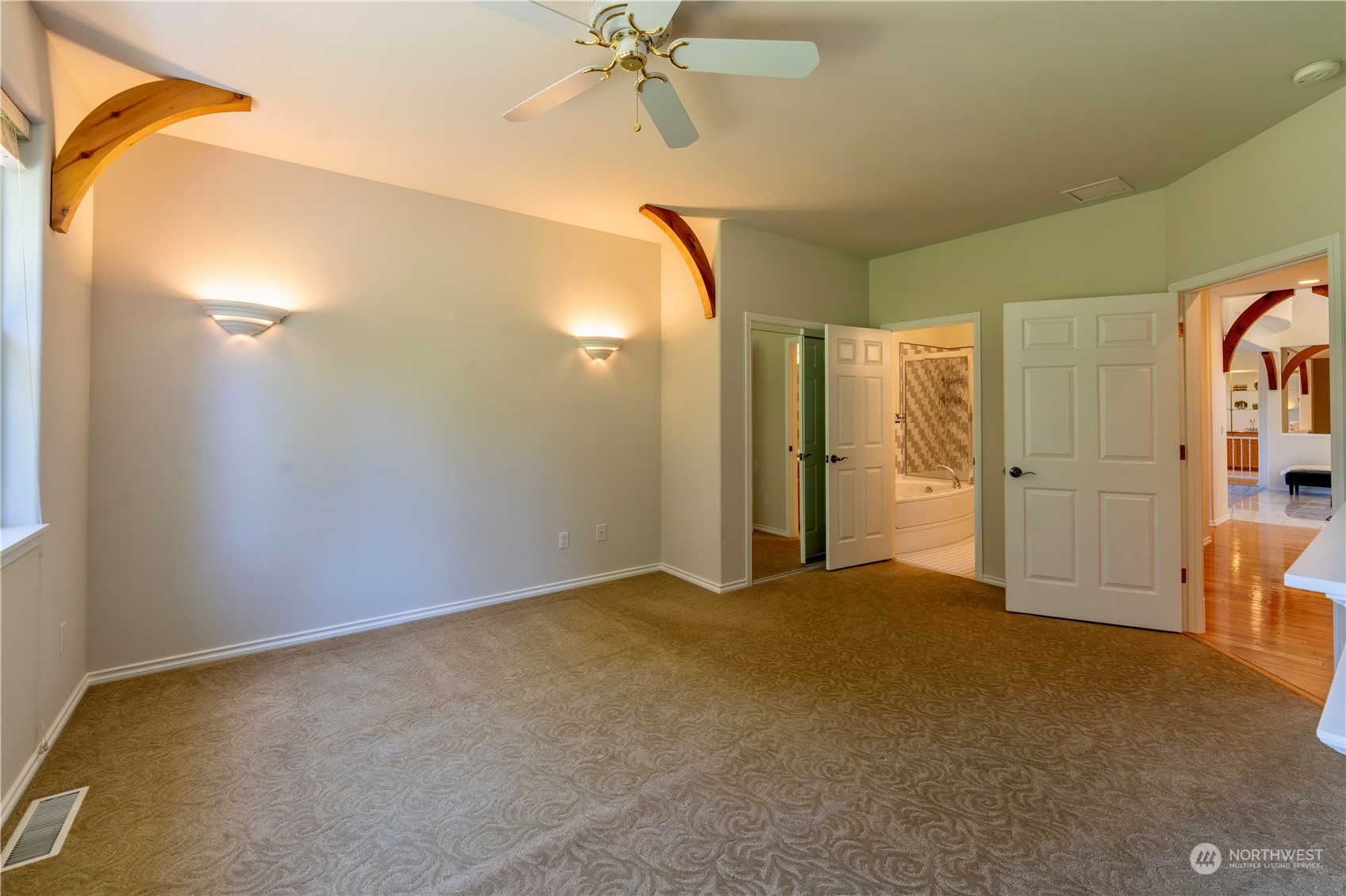 272 Ravens Ridge Road Sequim, WA 98382 - Photo 32 of 40 a view of a room with a mirror and a ceiling fan