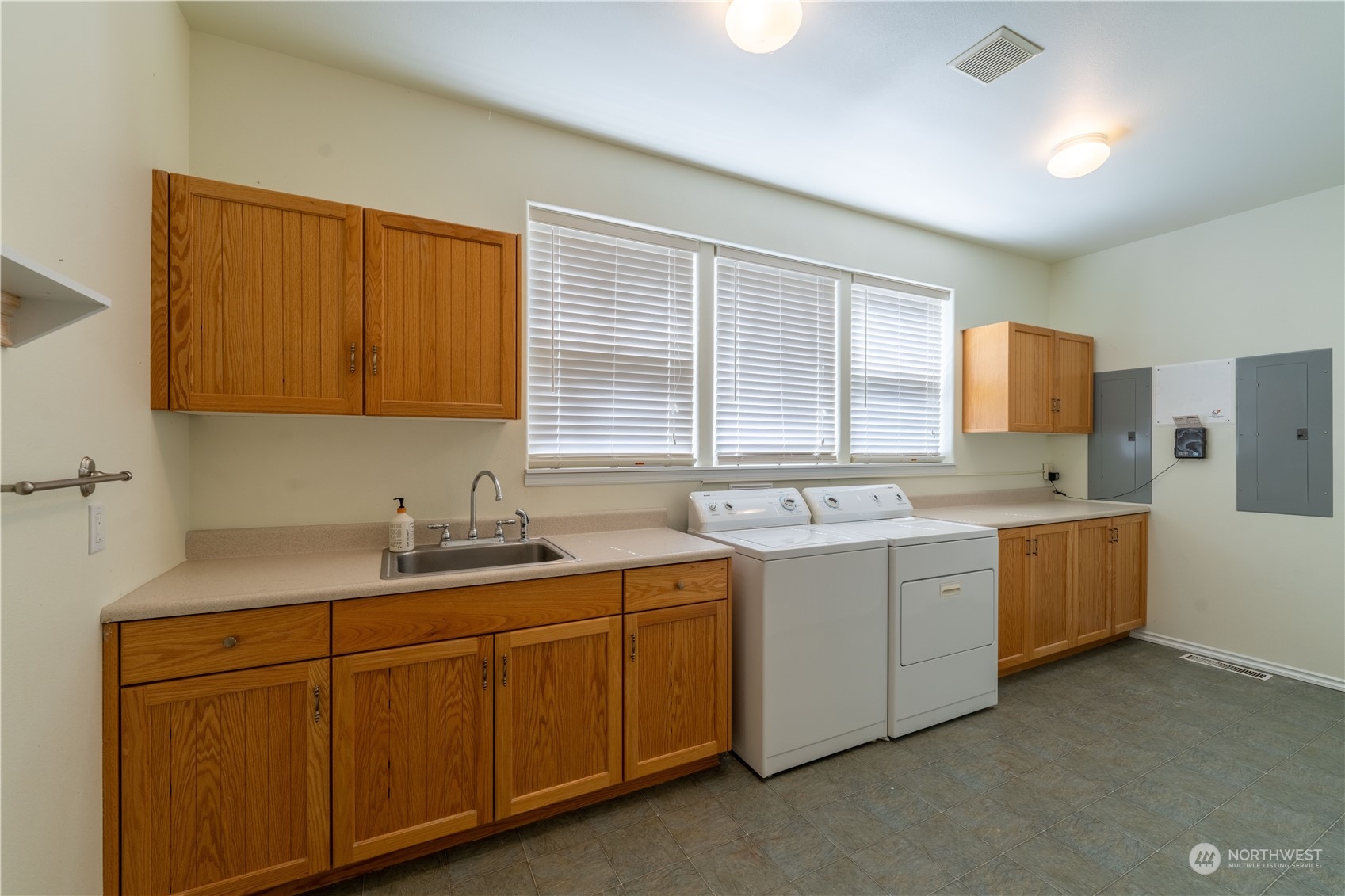 272 Ravens Ridge Road Sequim, WA 98382 - Photo 36 of 40 a utility room with cabinets washer and dryer