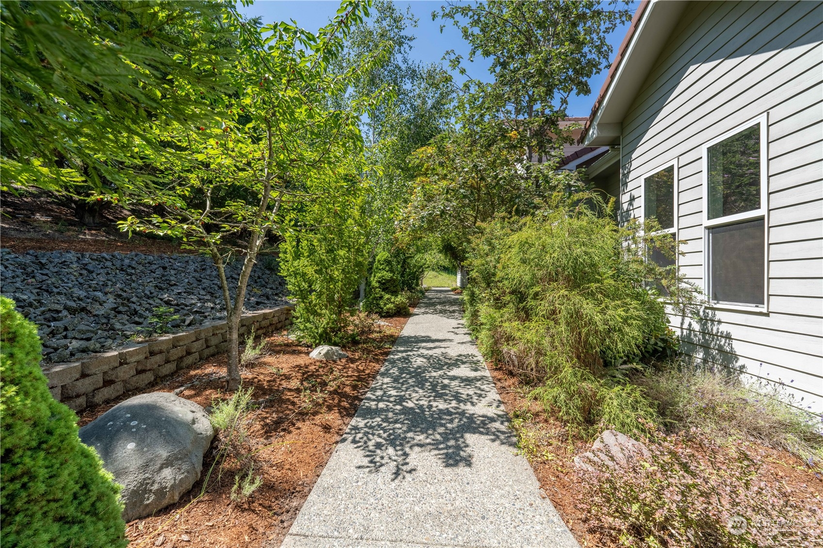 272 Ravens Ridge Road Sequim, WA 98382 - Photo 4 of 40 a backyard of a house with lots of green space