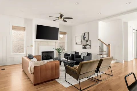 a living room with furniture a fireplace and a flat screen tv