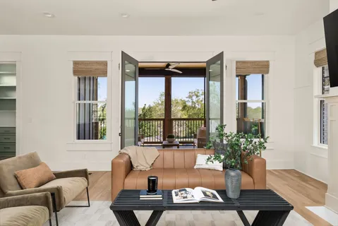 a living room with furniture and a potted plant