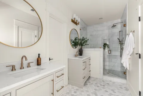 a bathroom with a sink a mirror a vanity and shower