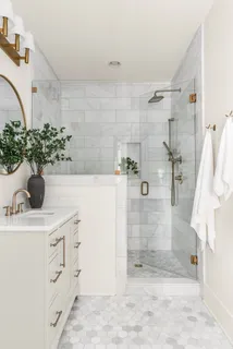 a bathroom with a shower sink and mirror