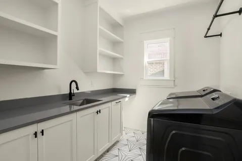 a kitchen with a sink stove and cabinets