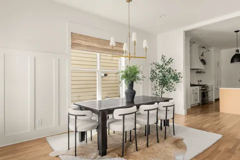 a dining room with furniture and wooden floor