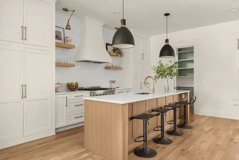 a kitchen with stainless steel appliances granite countertop a sink a stove and a wooden floors