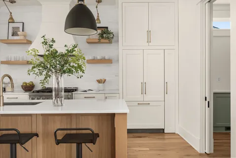 a kitchen with cabinets and window