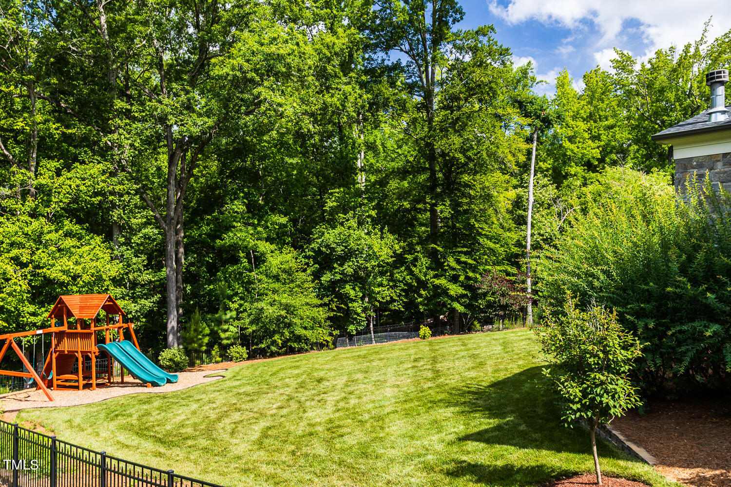 11405 Royal Amber Way Raleigh, NC 27614 - Photo 54 of 61 a view of a backyard with plants and a patio