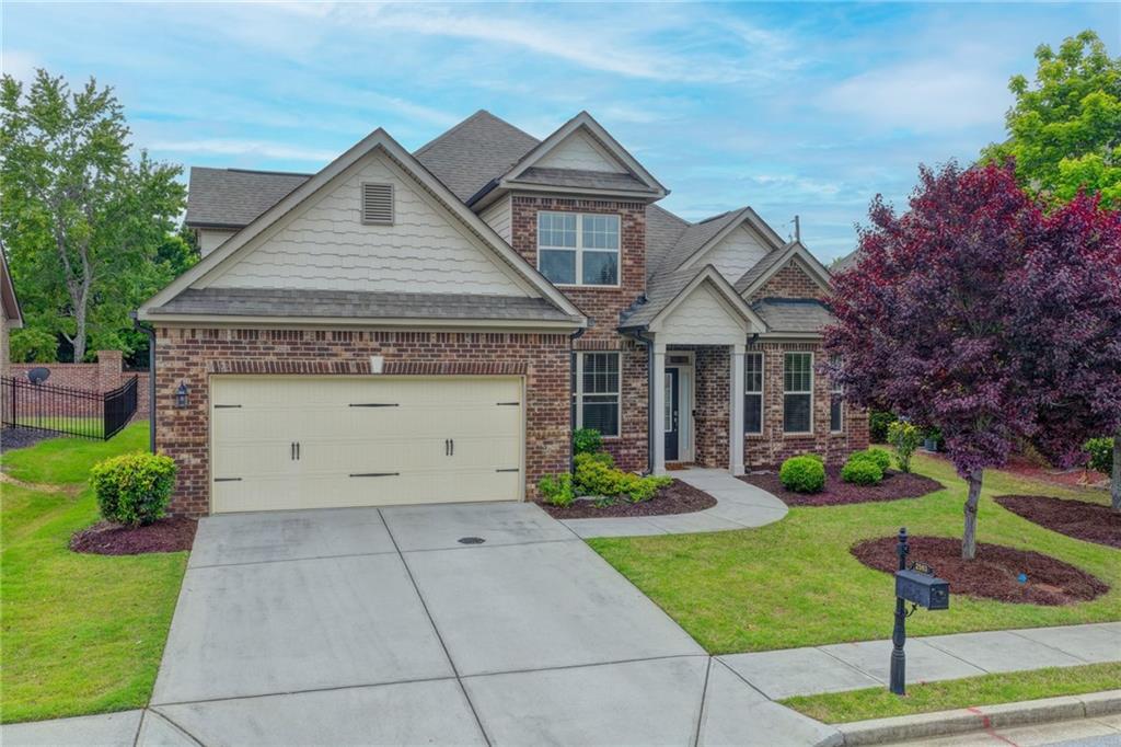 2583 Madison Mae Lane Grayson, GA 30017 - Photo 1 of 43 a front view of a house with a yard and trees