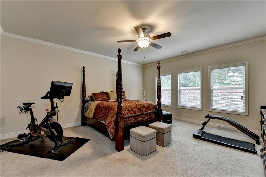 2583 Madison Mae Lane Grayson, GA 30017 - Photo 22 of 43 a bedroom with furniture and a large window