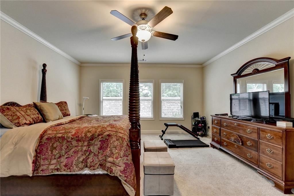 2583 Madison Mae Lane Grayson, GA 30017 - Photo 23 of 43 a bedroom with a bed dresser and a window